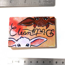 Load image into Gallery viewer, yellow/red wood magnet, hand painted, bottom features a white goat, with the word &quot;clean&quot; above them, at the top, upside down is a brown goat with little red horns with the word &quot;Dirty&quot; above them
