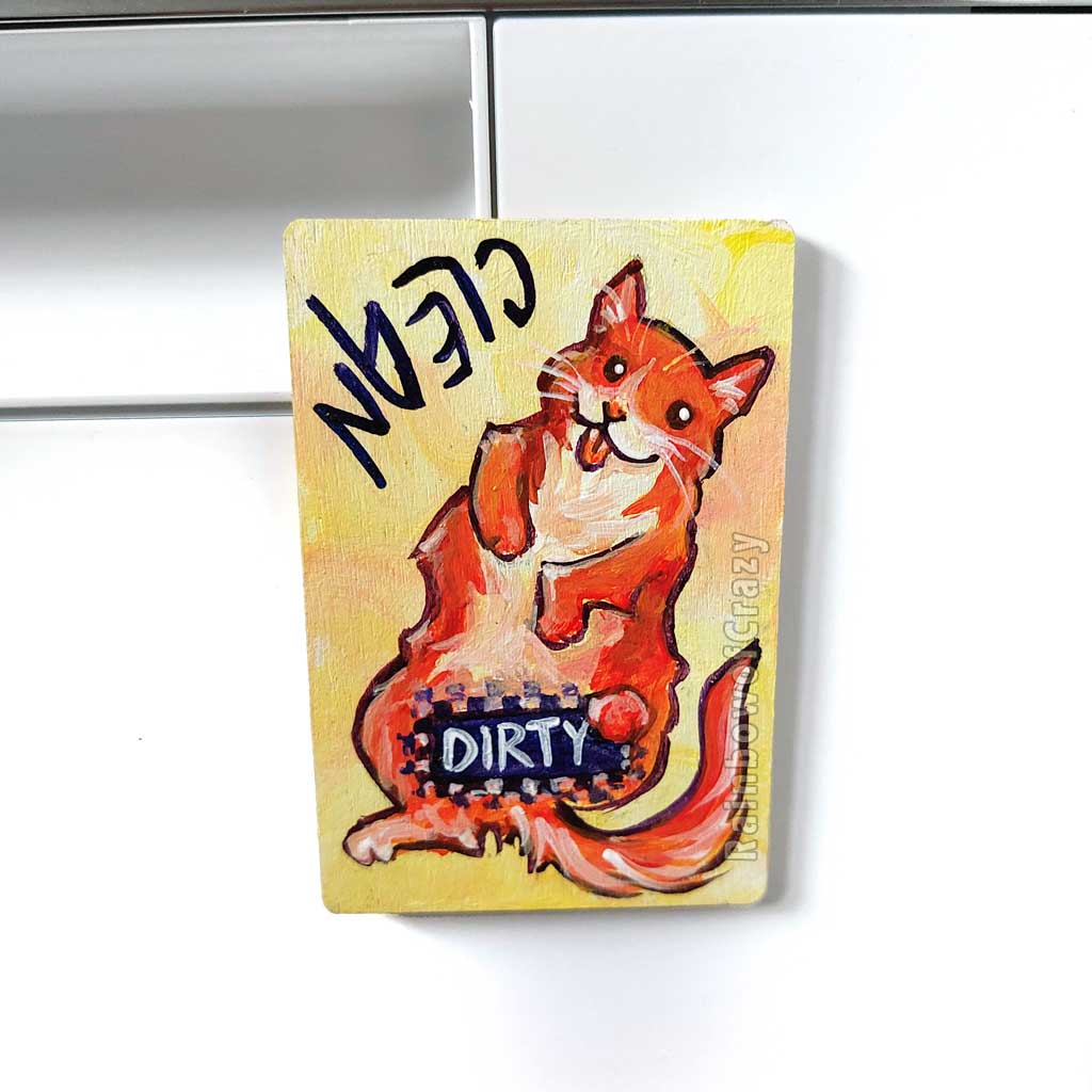 yellow wood magnet, hand painted with an orange cat with its tongue out. near the top of the cat's head is the word CLEAN. a black bar covers the cat's crotch and says the word DIRTY. around the bar, the cat's body is pixelated