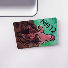 Load image into Gallery viewer, wood magnet on a dishwasher, hand painted with a pig with the word CLEAN (upside down) next to its face at the top. the second half of the pig is muddy, and written next to its body, DIRTY.
