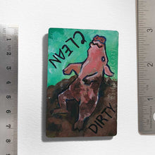 Load image into Gallery viewer, wood magnet on a dishwasher, hand painted with a pig with the word CLEAN (upside down) next to its face at the top. the second half of the pig is muddy, and written next to its body, DIRTY.
