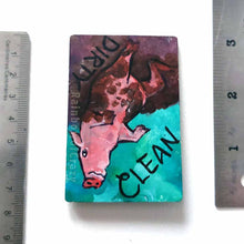 Load image into Gallery viewer, wood magnet on a dishwasher, hand painted with a pig with the word CLEAN (upside down) next to its face at the top. the second half of the pig is muddy, and written next to its body, DIRTY.
