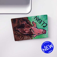 Load image into Gallery viewer, wood magnet on a dishwasher, hand painted with a pig with the word CLEAN (upside down) next to its face at the top. the second half of the pig is muddy, and written next to its body, DIRTY.
