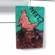 Load image into Gallery viewer, wood magnet on a dishwasher, hand painted with a pig with the word CLEAN (upside down) next to its face at the top. the second half of the pig is muddy, and written next to its body, DIRTY.
