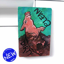 Load image into Gallery viewer, wood magnet on a dishwasher, hand painted with a pig with the word CLEAN (upside down) next to its face at the top. the second half of the pig is muddy, and written next to its body, DIRTY.
