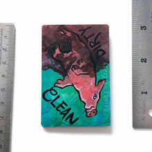 Load image into Gallery viewer, wood magnet on a dishwasher, hand painted with a pig with the word CLEAN (upside down) next to its face at the top. the second half of the pig is muddy, and written next to its body, DIRTY.
