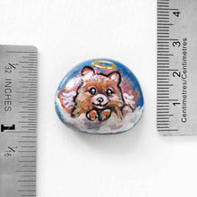 Load image into Gallery viewer, a small stone, hand painted with a portrait of a Pomeranian dog as an angel in the clouds, available as a keepsake stone or pendant necklace 
