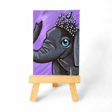 Load image into Gallery viewer, an aceo sized painting on a wood easel, featuring an elephant wearing a tiara, painted against a soft purple background
