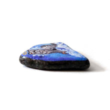 Load image into Gallery viewer, a small beach stone, painted with a portrait of a ferret as an angel in the clouds
