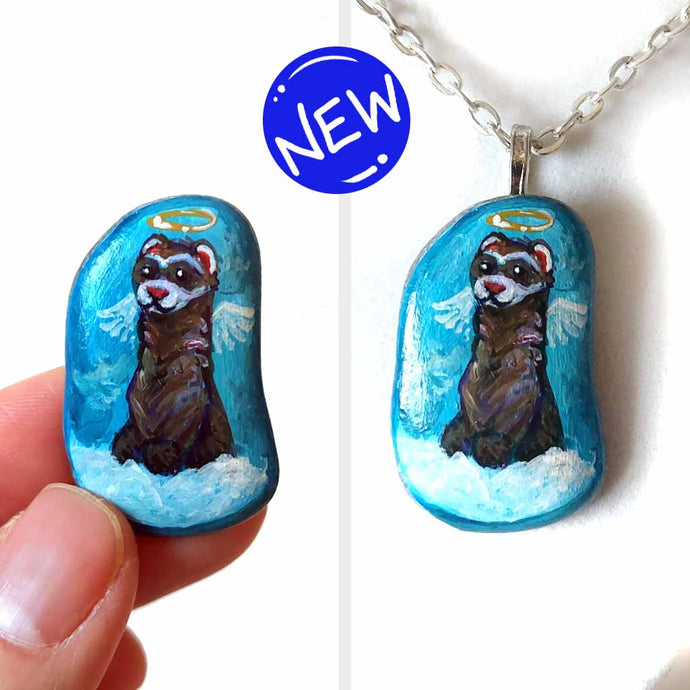 a small beach stone, painted with a smiling ferret angel, with halo and wings, on top of clouds, against a blue sky. available as a keepsake, magnet or pendant necklace