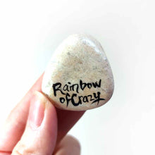 Load image into Gallery viewer, a small beach stone, hand painted with a portrait of a brindle french bulldog, as an angel in the clouds, signed with rainbowofcrazy
