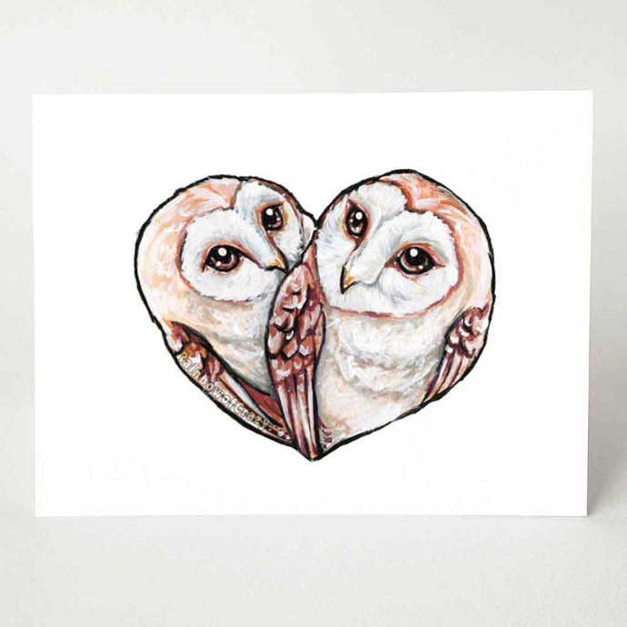 A greeting card featuring art of two barn owls, curled up in the shape of a heart.