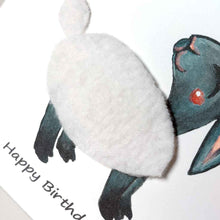 Load image into Gallery viewer, a greeting card featuring an illustration of a smiling black sheep with white fleece, wearing a rainbow party hat. its fleece is made with real fleece fabric. the front reads, &quot;Happy Birthday to Ewe!&quot;
