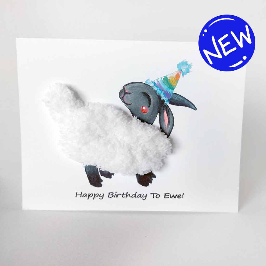 a greeting card featuring an illustration of a smiling black sheep with white fleece, wearing a rainbow party hat. its fleece is made with thick, chunky, white yarn. the front reads, 
