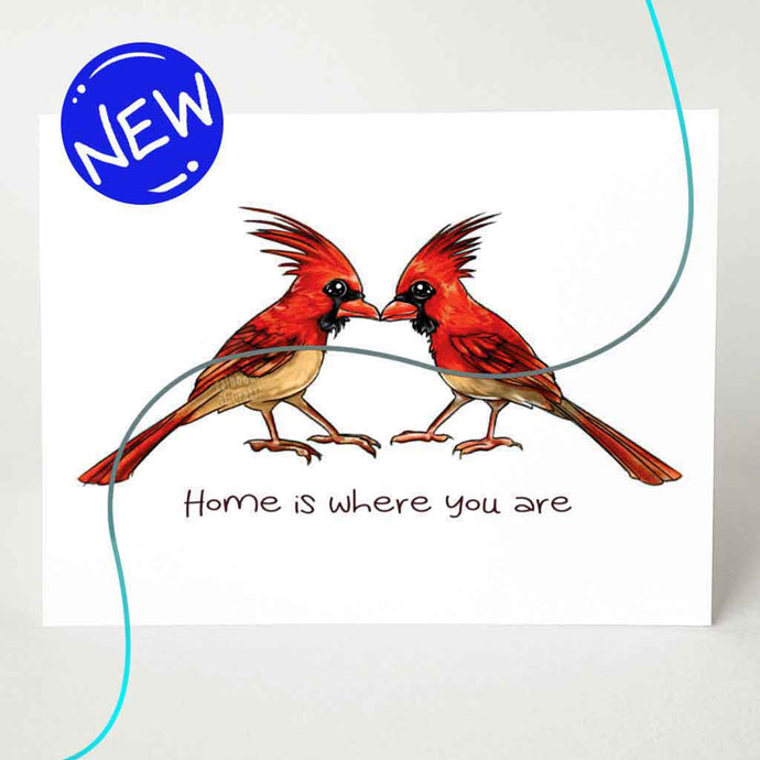 a greeting card featuring an illustration of two cardinals, beaks just touching. it reads, 