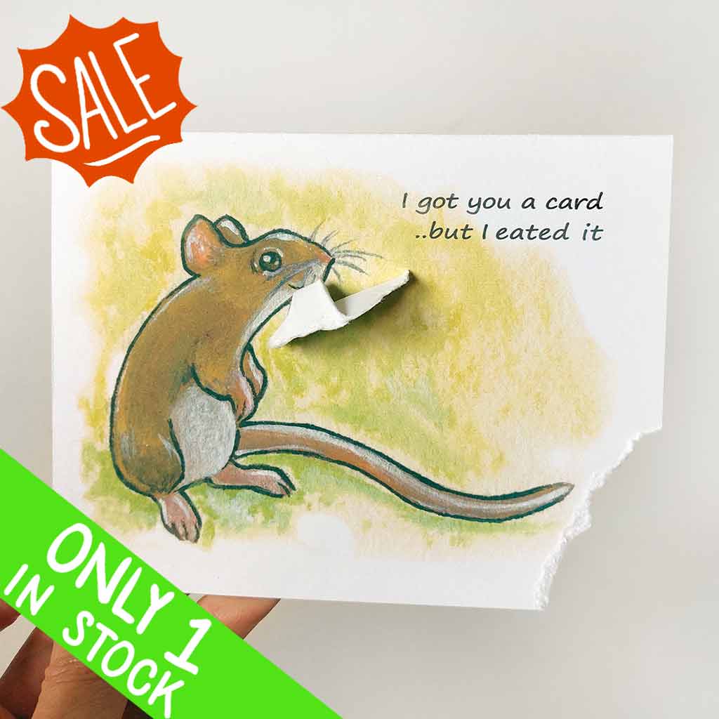 a greeting card, illustrated with a smiling mouse. a corner of the card is ripped and hangs from the mouse's mouth. the text reads, I got you a card .. but I eated it