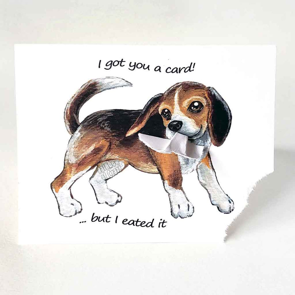 a greeting card, illustrated with a beagle. the bottom corner of the card is ripped and hangs from the dog's mouth. front reads, I got you a card! ... but I eated it