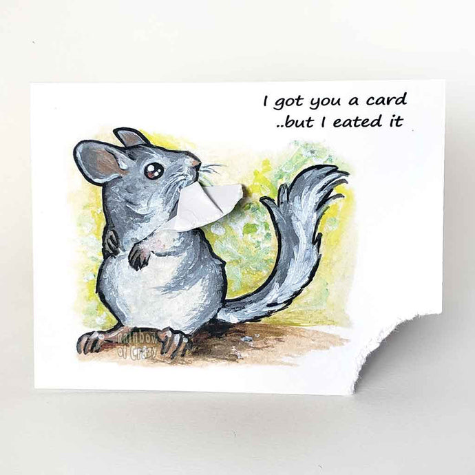 a greeting card featuring an illustration of a chinchilla, with the bottom left corner of the card hanging from its mouth. The card reads, I got you a card .. but I eated it