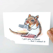 Load image into Gallery viewer, a greeting card, illustrated with a gerbil. the bottom corner of the card is ripped and hangs from the gerbil&#39;s mouth. front reads, I got you a card! ... but I eated it
