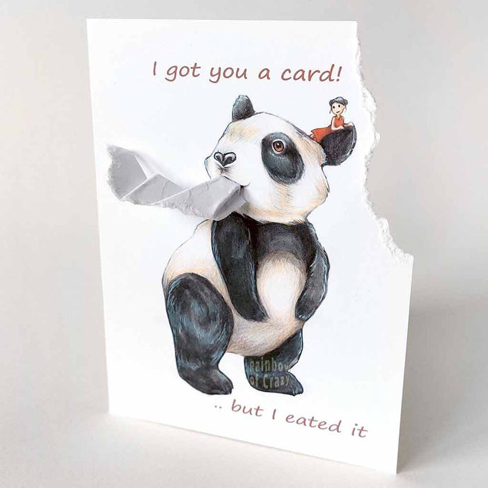 a greeting card illustrated with giant panda bear with a tiny person in a red dress, sitting on the panda's head. the top right corner of the card is ripped off and hangs from the panda's mouth. the front reads, 
