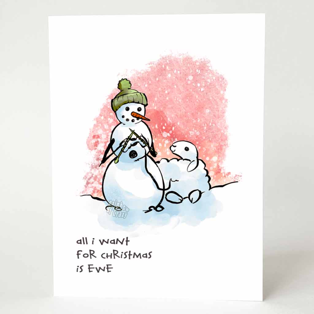 greeting card with an illustration of a smiling snowman wearing a green winter hat,  holding knitting needles as it knits from a smiling snow sheep. on the bottom, the card reads, 