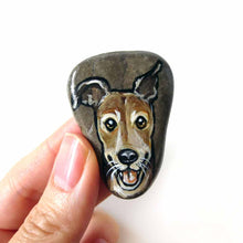 Load image into Gallery viewer, a beach rock painted with art of a close-up of a brown greyhound smiling, available as a stone, fridge magnet, or necklace

