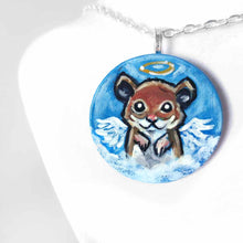 Load image into Gallery viewer, a lightweight wood disc, hand painted with a portrait of a hamster, painted as an angel with wings and a halo, sitting on the clouds against a blue sky. available as a wood keepsake or pendant necklace 
