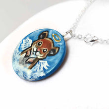 Load image into Gallery viewer, a lightweight wood disc, hand painted with a portrait of a hamster, painted as an angel with wings and a halo, sitting on the clouds against a blue sky. available as a wood keepsake or pendant necklace 
