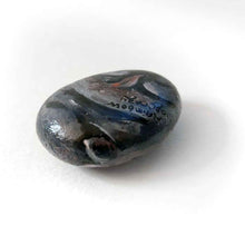 Load image into Gallery viewer, a small beach stone painted to looke like a smiling baby hippo
