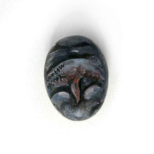 Load image into Gallery viewer, a small beach stone painted to looke like a smiling baby hippo. the underside features the hippo&#39;s bottom and is signed with, RainbowofCrazy
