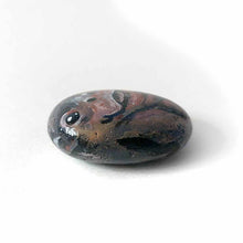 Load image into Gallery viewer, a small beach stone painted to looke like a smiling baby hippo
