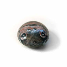 Load image into Gallery viewer, a small beach stone painted to looke like a smiling baby hippo
