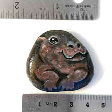 Load image into Gallery viewer, a smooth, flat, beach stone hand painted with a smiling hippo
