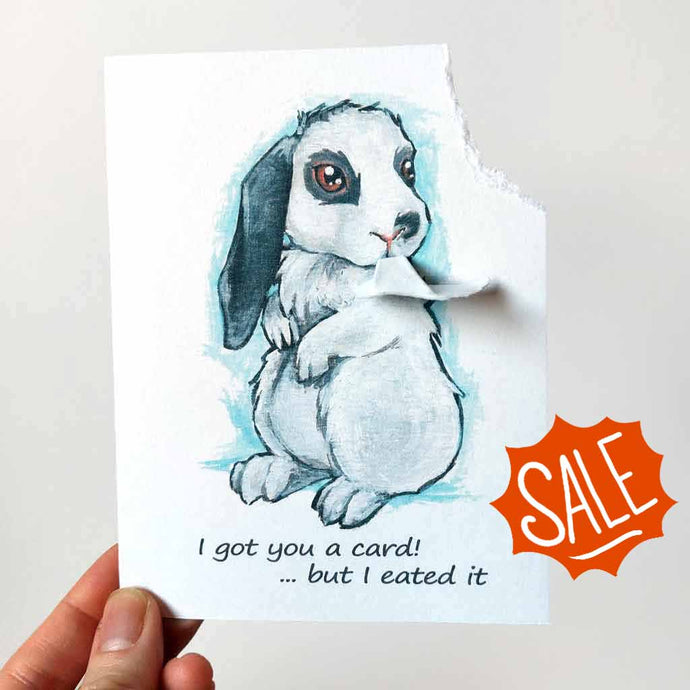a greeting card with art of a white and gray mini lop rabbit. The card reads, 