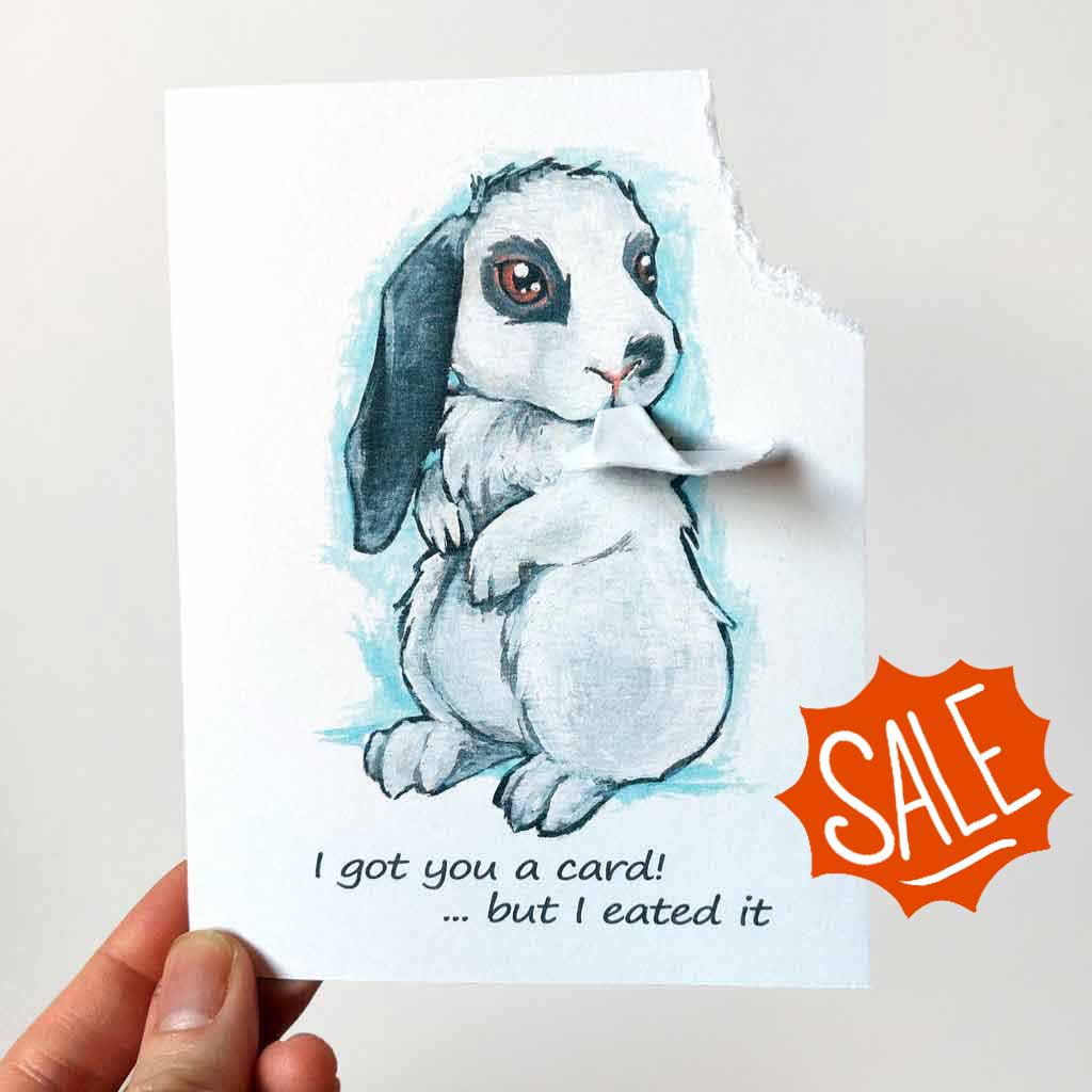 a greeting card with art of a white and gray mini lop rabbit. The card reads, 