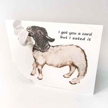 Load image into Gallery viewer, a funny greeting card with a black and white sheep on the front, with the bottom left corner of the card ripped and hanging from its mouth. the card reads, &quot;I got you a card and I eated it&quot;
