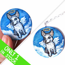 Load image into Gallery viewer, a lightweight wood disc, hand painted with a portrait of a husky dog as an angel in the clouds against a blue sky. available as a keepsake or pendant necklace
