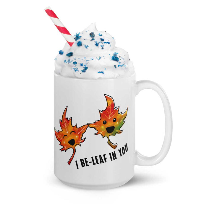 A 15 oz white ceramic mug, printed with art of two maple leaves with happy faces, and the words. 