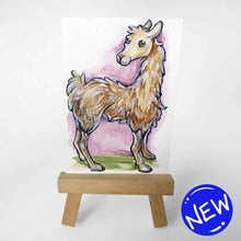 Load image into Gallery viewer, aceo sized painting of a smiling llama against a soft purple and green background. the painting rests on a small wood easel
