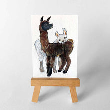 Load image into Gallery viewer, an aceo sized painting of a brown and black llama, with a white llama behind, resting their head on the brown llama&#39;s back
