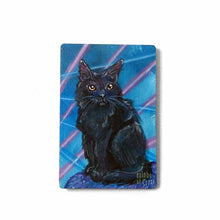 Load image into Gallery viewer, small wood rectangle fridge magnet, hand painted with a portrait of a fluffy black cat with yellow eyes, posing in front of a retro 80s / 90s blue background with blue and pink lasers
