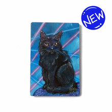 Load image into Gallery viewer, small wood rectangle fridge magnet, hand painted with a portrait of a fluffy black cat with yellow eyes, posing in front of a retro 80s / 90s blue background with blue and pink lasers
