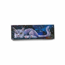 Load image into Gallery viewer, small wood rectangle fridge magnet, hand painted with a portrait of a fluffy cat painted in purples, blues, and grays, lying down against a galaxy background of stars
