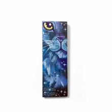 Load image into Gallery viewer, small wood rectangle fridge magnet, hand painted with a close-up portrait of a fluffy cat painted in purples and blues, closely resembling a lion, against a galaxy background of stars
