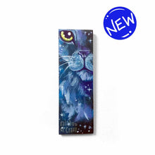 Load image into Gallery viewer, small wood rectangle fridge magnet, hand painted with a close-up portrait of a fluffy cat painted in purples and blues, closely resembling a lion, against a galaxy background of stars
