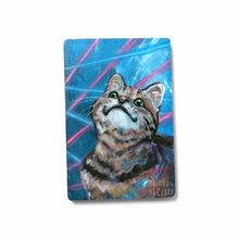 Load image into Gallery viewer, small wood rectangle fridge magnet, hand painted with a portrait of a brown tabby cat looking up with a smile, posing in front of a retro 80s / 90s blue background with blue and pink lasers
