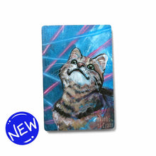 Load image into Gallery viewer, small wood rectangle fridge magnet, hand painted with a portrait of a brown tabby cat looking up with a smile, posing in front of a retro 80s / 90s blue background with blue and pink lasers
