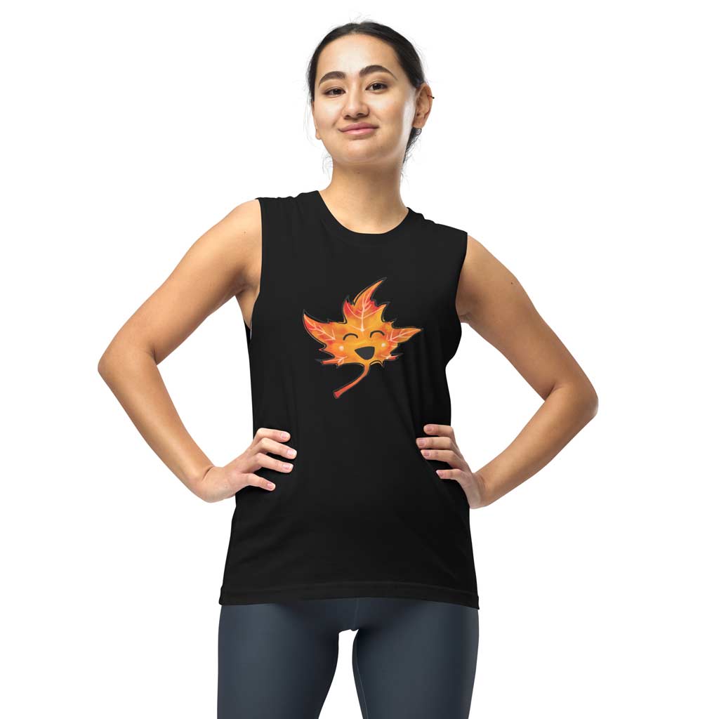 person is wearing a unisex muscle tank top in the colour black, featuring a graphic of a smiling maple leaf