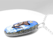 Load image into Gallery viewer, a small beach stone, hand painted with a little brown and white mouse as an angel in the clouds, with a halo and wings. the stone is available as a keepsake rock art or as a pendant necklace
