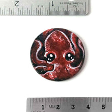 Load image into Gallery viewer, a lightweight wood disc, hand painted with a portrait of a red baby octopus. the painting is available as a keepsake, or pendant necklace
