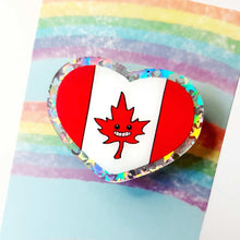 Load image into Gallery viewer, heart acrylic pin featuring the Canada flag, the maple leaf stylized with happy face.
